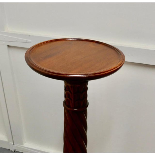 This is a fine quality pair of mahogany torchères They have a circular flat top with a raised moulded rim. They each stand...