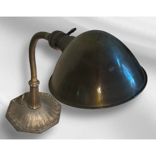 This desk lamp is sturdy sight! The brass base has a subtle, fluted design, leading up to a gooseneck stem, allowing you...