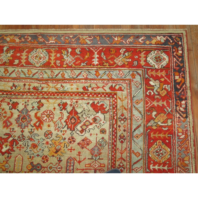 An early 20th century square size antique Turkish Oushak featuring an-all over design in warm colors. 11' x 11'8''