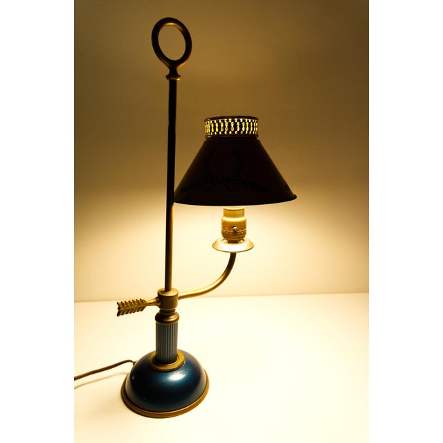 An elegant early 20th-century French-style bouillotte tole table lamp, featuring classic painted metal detailing and...