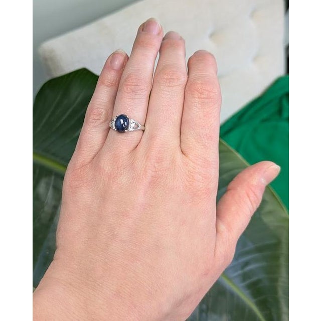 4.15 cts star sapphire ring showcasing a luminous 10×8mm gemstone, highlighted by sparkling natural diamond accents....