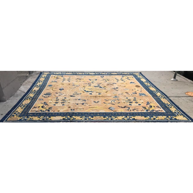 An antique 18 century vintage Chinese ningshia rug. It’s measures 12’ x 12’ it’s square. It’s has wear showing. It has...