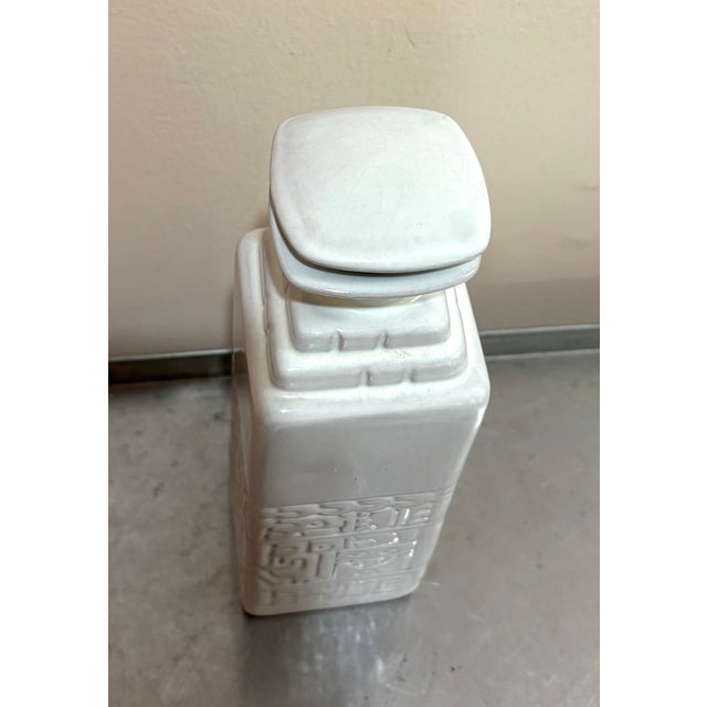 1950s-60s Frankoma white glazed terra cotta tribal-style lidded decanter/bottle. Some surface crazing around neck of...