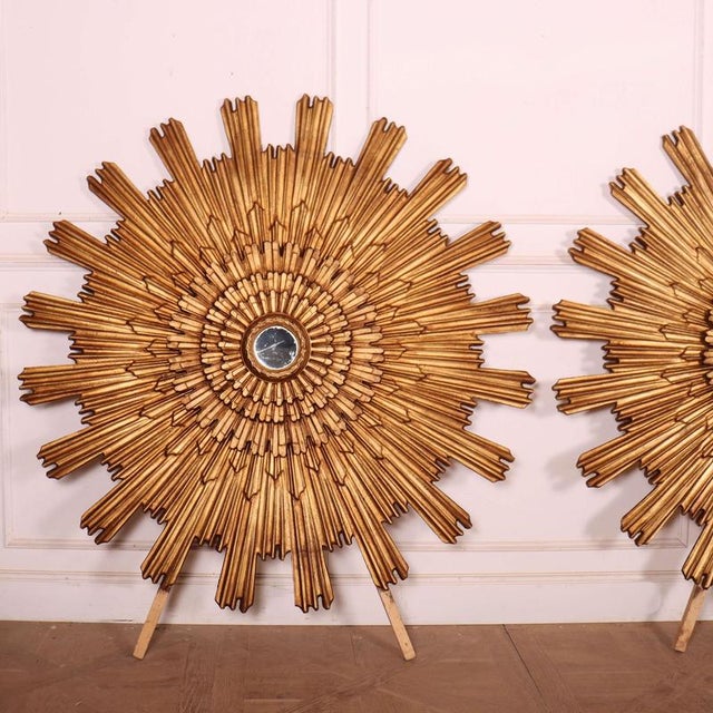 Striking pair of large Italian gilt sunburst mirrors. 1950 Dimensions:W: 160cm (63")H: 160cm (63")D: 12cm (4.7") This...