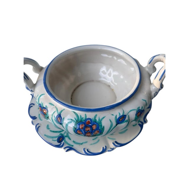 A fine example of mid-century Italian majolica, this hand-painted tureen with underplate showcases the artistry and...