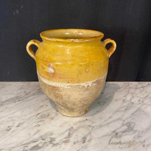 Antique Country French Confit Pot with double handles and classic mustard yellow glaze. Used originally to preserve...