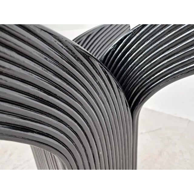 Vintage dining table with a round clear glass top and a black rattan base. Produced by Vivai del Sud in France. Good...