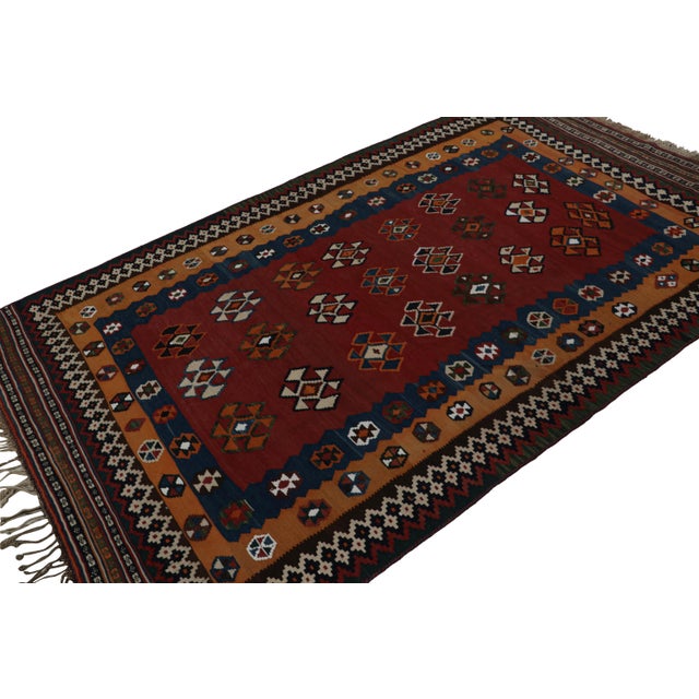 Handwoven in wool, circa 1950-1960, this 5x9 vintage Afghan tribal Kilim rug, with geometric patterns, is a special...