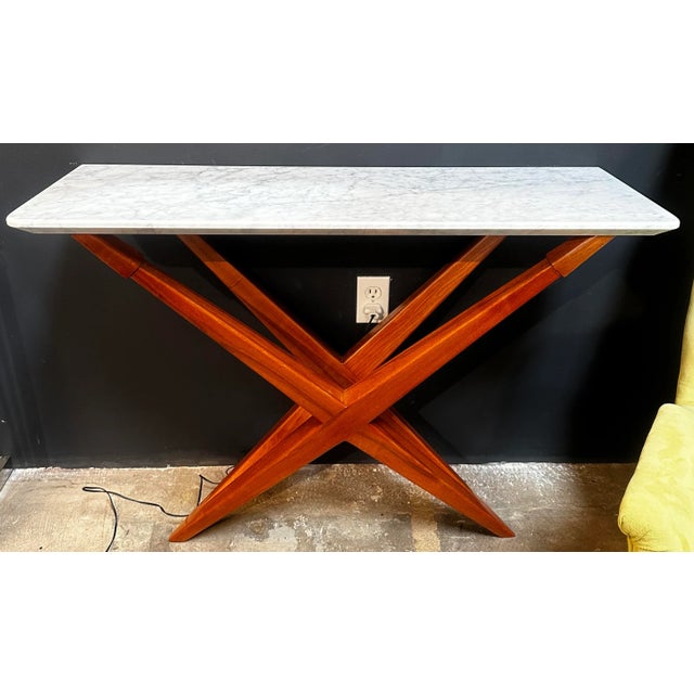 This beautiful console table is made from solid walnut wood pieces forming this wonderful architectural design. The...