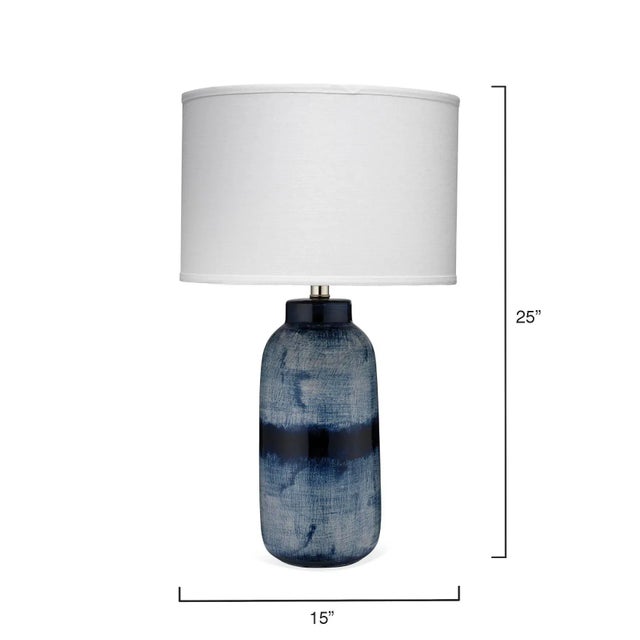 Inspired by Japanese ceramics, this lamp is a stunning ceramic accent that features a deep indigo reactive glaze that...