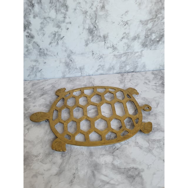 Vintage Mid Century Brass Turtle Shaped Brass Trivet. It has a honeycomb design and is footed. It can be used for kitchen...