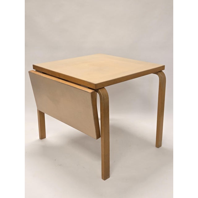 Artek drop-leaf table, design by Alvar Aalto. The table has cream linoleum top. The table is from around 1950s, in...