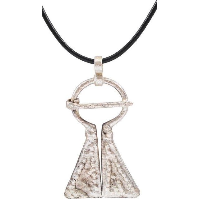 Large example, just under 2” (1.95”) height of omega form. Circular top with large triangular terminals decorated in...