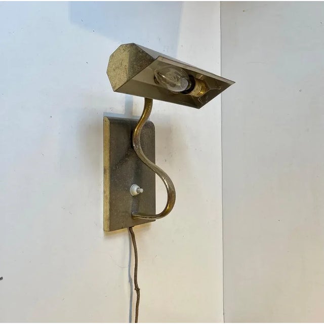 A stylish 1930s wall light in solid patinated brass. Made in sweden during the 1930s, probably by asea, in a style...