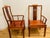 Gorgeous pair of Chinese teak wood horseback armchairs , handcarved with a symbol of longevity on the back in beautiful...