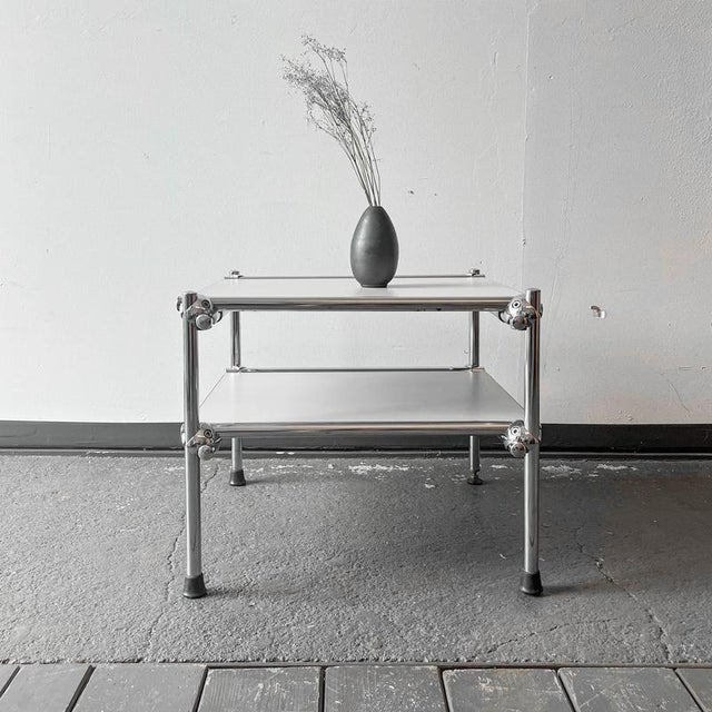 Product. Side table style. 1990s material. Tubular steel frame · chrome-plated · plywood panels · gray coated equipment....