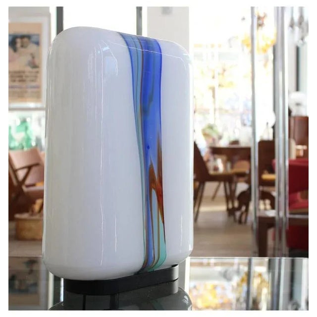 Painted steel, opaline glass with polychrome band. Table lamp with polychrome band 1970-80ModelTable lamp with polychrome...