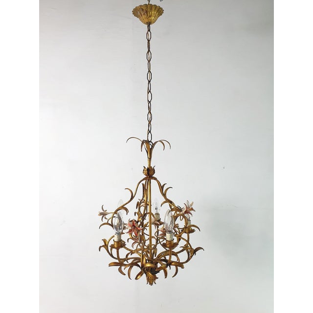Chandelier from the 1950s in iron and painted with a natural vintage patina. It has six candle lights surrounded with...