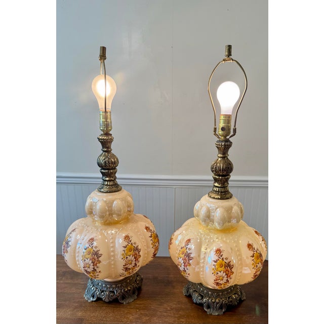 This is a pair of Mid-Century Modern Hollywood Regency lamps featuring a distinctive opalescent ‘bubble’ glass body...