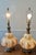 This is a pair of Mid-Century Modern Hollywood Regency lamps featuring a distinctive opalescent ‘bubble’ glass body...