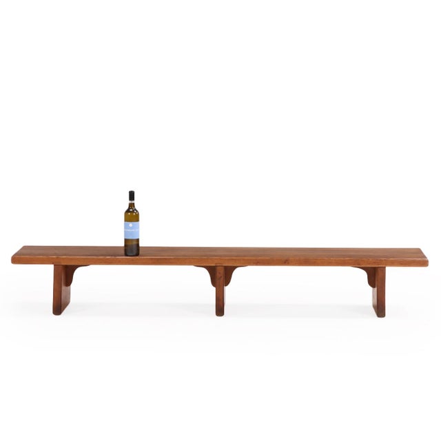 Elegant solid oak bench of French origin, with thick slab resting on three sculptural supports. The restrained,...
