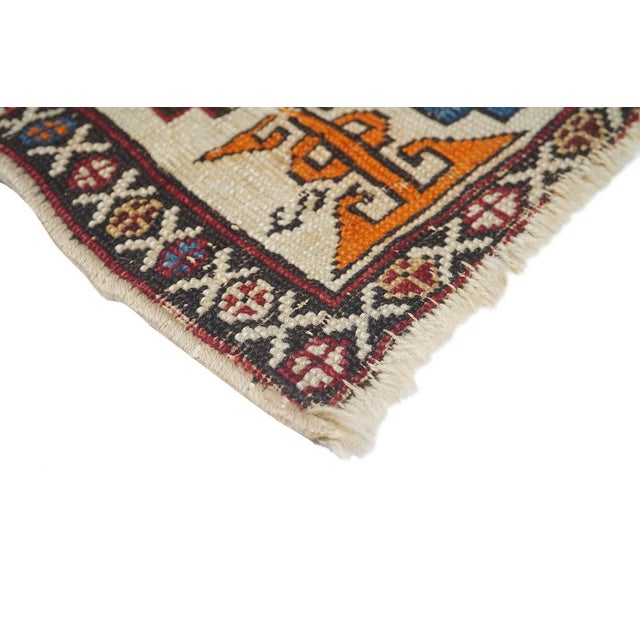 In somewhat spot-distressed, shabby chic condition, this east Caucasian scatter features a dark blue ground and three...