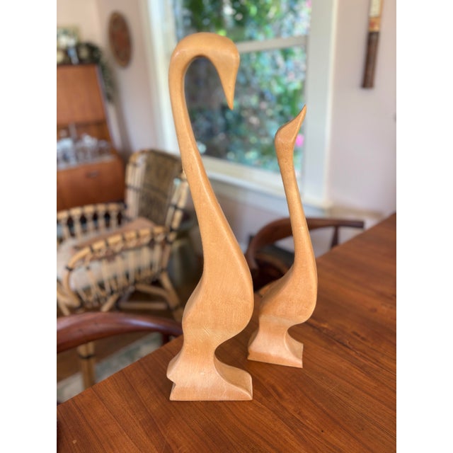 Striking pair of hand-carved wooden goose sculptures, signed/inscribed “H. Baigmohammad” and dated “4-25-78” on the...
