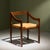This chair by Jean Gillon features a wooden frame with a finish that highlights the natural grain of the material. The...