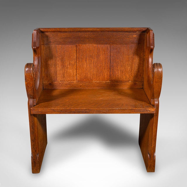 This is an antique hallway settle. A Scottish, oak two seat bench or ecclesiastical pew with Gothic revival taste, dating...