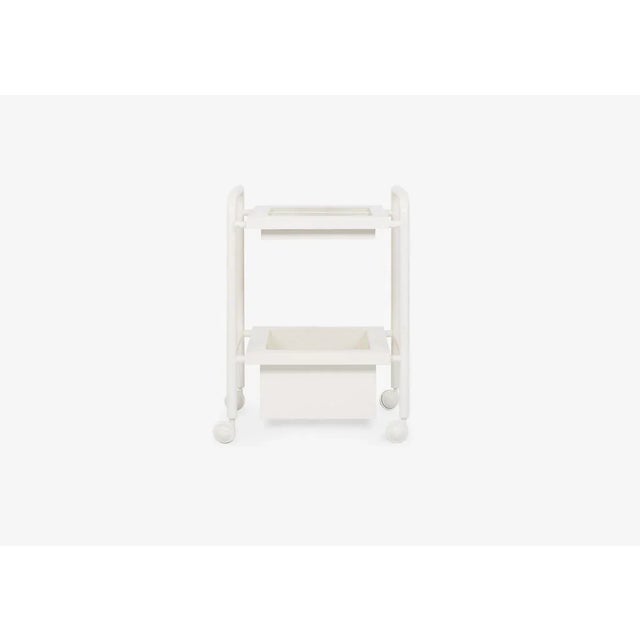 Side table composed of 1 lacquered steel structure with wheels and 2 tops in lacquered MDF. The Living tops have a recess...