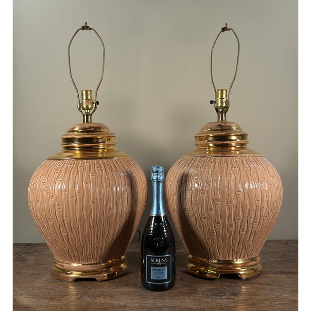 This fabulous pair of table lamps features ginger jar shaped ceramic bodies with raised faux bamboo texturing in a warm...