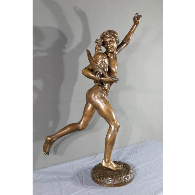 This brown patina bronze sculpture, entitled "Vainqueur au Combat de Coq", is signed Alexandre Falguière (1831-1900) on...