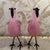 Pair of pink and clear glass blown glass flamingo figures with black glass beaks and eyes and black metal legs. The wings...