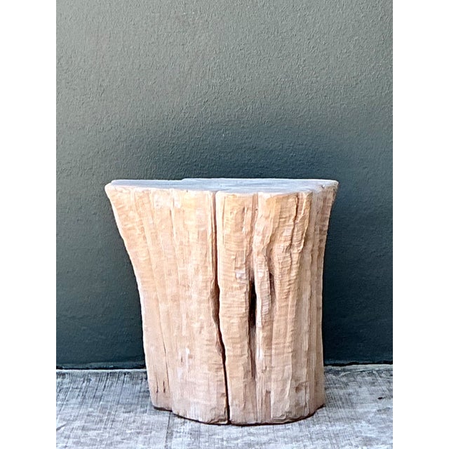 This vintage accent table is formed from a single section of natural wood, celebrating the raw, organic shape of a tree...