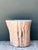 This vintage accent table is formed from a single section of natural wood, celebrating the raw, organic shape of a tree...