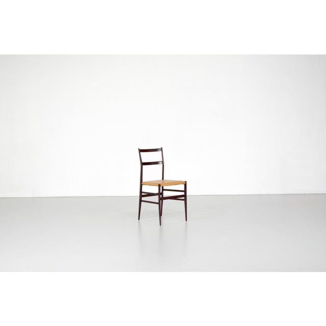 Superleggera chair, model number 699, with a wooden frame, upholstered seat, and leather (Skai) covering. Designed by Gio...