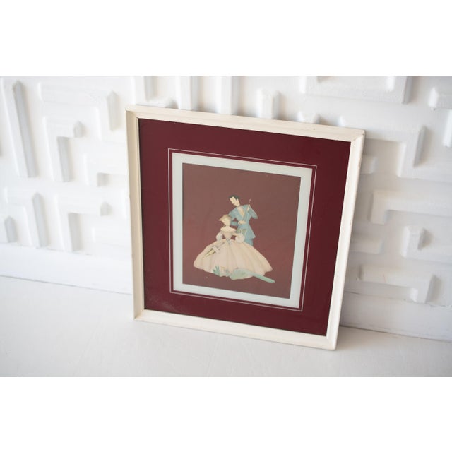 This listing is for a vintage print featuring an Edwardian/Art Deco Couple. It is a deep red color with glass overtop and...
