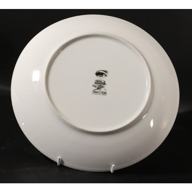 The Shadowed Muse: Fornasetti "Themes & Variations" Plate #114 (Half Face) A striking and minimalist porcelain wall plate...