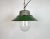 Industrial hanging lamp manufactured in Poland during the 1960s. It features a green enamel shade with a white enamel...