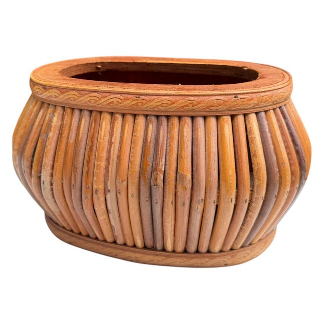 Distinctive vintage rattan cachepot with a beautifully sculptural, rounded form. The body is constructed from individually...