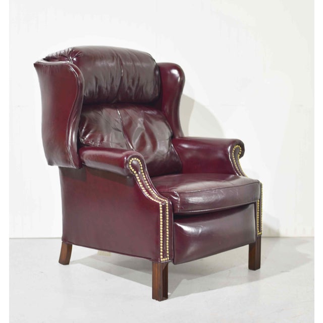 Rich in character and timeless in style, this vintage oxblood leather wingback chair embodies classic library elegance...