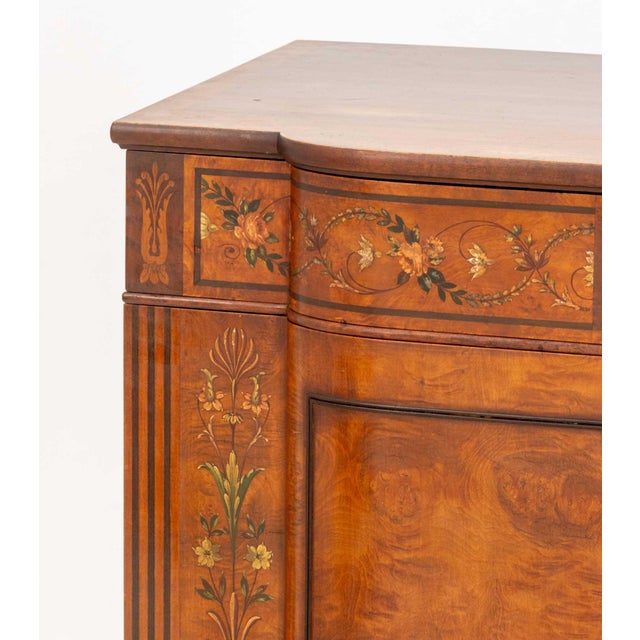 Edwardian Paint-Decorated Satinwood Commode, with painted floral motif and two cabinet doors opening to three drawers....
