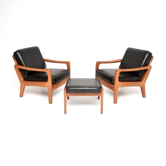 A very stylish and extremely comfortable pair of Danish vintage teak and leather armchairs with stool by Juul Kristensen....