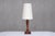 This tall Art Deco table lamp was produced in France in the 1920s. The striking design is marked by the square base with...