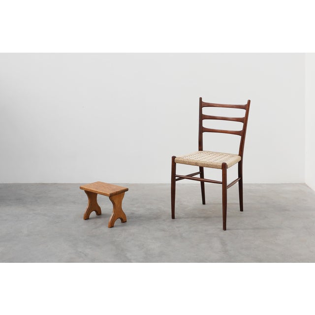 A finely hand‑carved oak stool from France, dating to around 1900. This compact piece embodies the quiet elegance of rural...