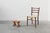 A finely hand‑carved oak stool from France, dating to around 1900. This compact piece embodies the quiet elegance of rural...