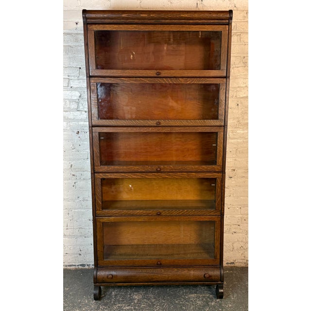 This Antique Lundstrum barrister bookcase was made in Little Falls, NY in 1927. Made up of five stacking sectional pieces...