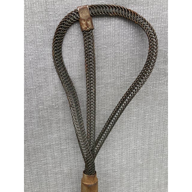 Antique woven wire and wood primitive rug beater. Marked Hercules. Good condition with wear consistent with age. It...