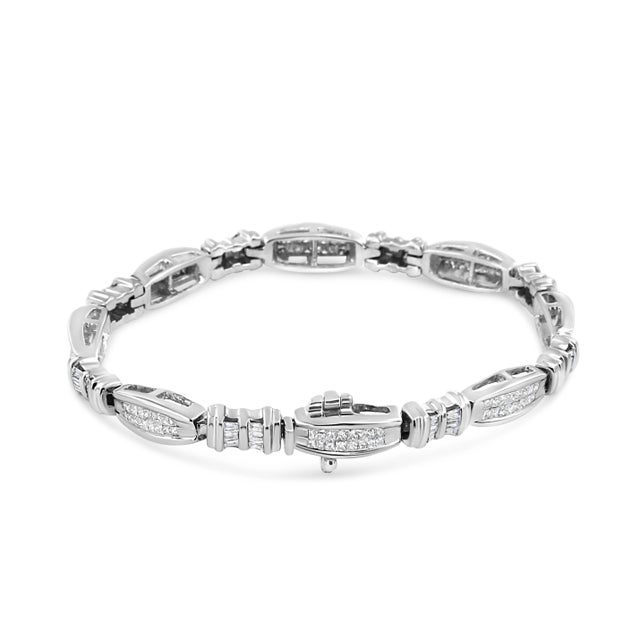 This stunning link bracelet is a great accessory. Crafted in 14k white gold, this design features channel set, princess...