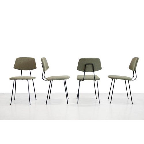 Great set of four dining chairs by Rudolf Wolf for Elsrijk. The frame is made of black lacquered metal and the chairs are...